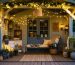 An inviting she shed interior at dusk, featuring a variety of lighting fixtures including string lights, pendant lamp, and wall sconces, creating a warm and cozy ambiance.
