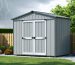 Artistic representation of a windproof storage shed with reinforced walls and anchoring, surrounded by strategic landscaping for wind protection.