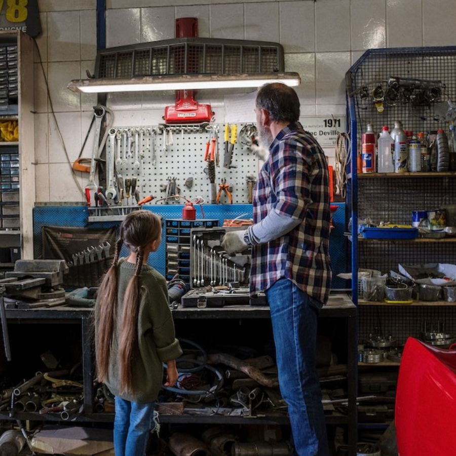 man and daughter cleaning and organizing tools