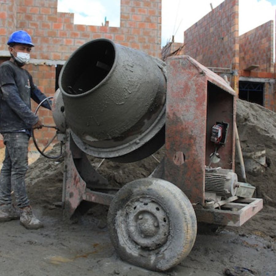 man mixing cement and sand with a mixer