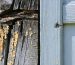 Close-up showing varying stages of wood rot on a shed corner, contrasted with healthy wood, highlighting discoloration, soft texture, and fungal growth.