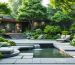 A tranquil backyard office with layered evergreen trees and shrubs, featuring a calming water feature that enhances the peaceful atmosphere and noise reduction.