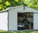 A well-ventilated storage shed surrounded by green trees and sunlight. The shed features visible roof and soffit vents, illustrating effective airflow and protection of stored belongings.