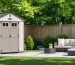 A serene backyard featuring a strategically placed portable garden shed providing privacy, surrounded by greenery and a comfortable seating area.