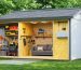 A detailed cross-sectional view of a shed showcasing various insulation materials such as fiberglass batts, foam boards, and reflective foil, emphasizing a cozy and well-organized interior workspace.