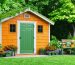 A beautifully painted garden shed in a vibrant green hue standing amidst a flourishing garden, showcasing the effects of eco-friendly paints made from natural, sustainable ingredients, symbolizing a commitment to environmental responsibility.