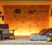 Interior view of a shed with plywood thermal barriers installed, featuring a cozy setup with visible wooden layers, a chair, and garden tools, illustrating effective insulation and warmth.