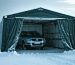 A sturdy portable garage with reinforced frames and heavy-duty cover stands firm in a snowstorm, partially sheltering a vehicle from harsh winter conditions, illustrating the structure's resilience and protective capabilities.