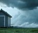 A garden shed secured with various wind anchor systems during a storm, showcasing its stability amidst swirling winds and stormy weather.