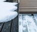 A split-screen depiction of a winter deck with hazardous snow and ice on one side and a clear, dry surface on the other, illustrating the effectiveness of a snow melt system.