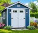 A picturesque shed painted with zero VOC paint, surrounded by blooming flowers and greenery, representing a clean and eco-conscious outdoor space.