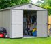 Large Duramax Woodbridge Plus storage shed with open double doors, displaying organized storage of lawn mower, bicycles, and garden tools amidst a well-maintained backyard setting.