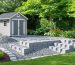 Illustration of a 7x7 shed with an eco-friendly foundation, showcasing recycled concrete blocks and gravel, surrounded by a garden with native plants.