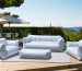 A modern outdoor patio scene displaying inflatable furniture transitioning from a fully inflated sofa and chairs to a compact, stored form, highlighting space-saving capabilities.