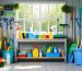 An inside view of a spotless storage shed featuring an organized collection of essential cleaning supplies in a dedicated caddy, emphasizing the importance of regular maintenance for a clean and protected space.