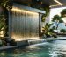 A tranquil urban terrace with a cascading wall fountain, lush greenery, and ambient LED lighting creating a peaceful atmosphere as the sun sets.