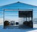 An outdoor workshop wrapped in reflective insulation, demonstrating protection from extreme weather; tools and equipment are visible inside, showcasing a well-maintained workspace.
