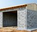 Illustration of a storage shed being built with load-bearing masonry materials like concrete blocks, bricks, and stones, highlighting the foundation and weight distribution for durability and stability.