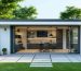 A modern modular shed office with large glass doors and windows, elegantly placed in a lush green backyard, showcasing a blend of nature and a professional working environment.