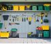 A fully organized shed interior featuring various shelving types like wall-mounted, corner, and overhead storage. The image displays neatly arranged tools, gardening supplies, and bins, illustrating the efficiency of smart shelving solutions.