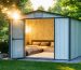 A well-insulated plastic shed displaying various insulation techniques like reflective foil and spray foam, set in a garden environment with contrasting weather conditions, representing year-round coziness.