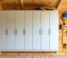 "Modern modular electrical enclosure with organized wiring installed on wooden shed wall."