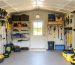 "Interior view of a shed with modular storage, adjustable shelves, and ample space, captured in bright daylight."