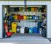 "Neatly arranged hazardous materials shed with labeled containers for chemicals and cleaning products, promoting home safety."