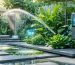A modern garden with a smart irrigation system featuring drip lines and smart controllers, set in a lush, green space that highlights the balance of technology and nature.