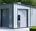 "A modern storage shed displaying smart technology integration, with a visible technology panel at the entrance, illuminated by soft daylight."
