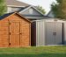Two portable storage sheds—one wooden and one metal—positioned side-by-side in a suburban backyard with the home and trees softly blurred behind.