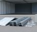 Galvanized steel carport components including roof panel sections, support posts with braces, anchor base plates, and an outdoor electrical box with conduit arranged for comparison.