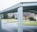 Close-up view of a coated galvanized steel carport frame with water droplets beading on the metal, suggesting corrosion protection.