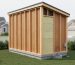 Medium-wide photo of a shed converted into a tiny house with visible construction details in a suburban yard under soft daylight.